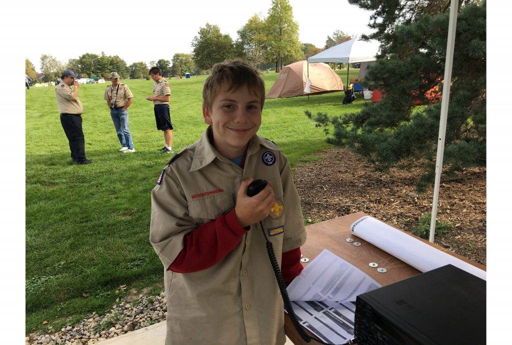 A boy scout communicates via ham radio